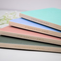 A5 hardcover imitation leather notebook with a mounted spine and gold-stamped logo, dot-matrix paper, and sewn binding